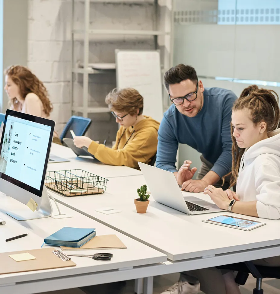 Picture of co-workers discussing things in the office.