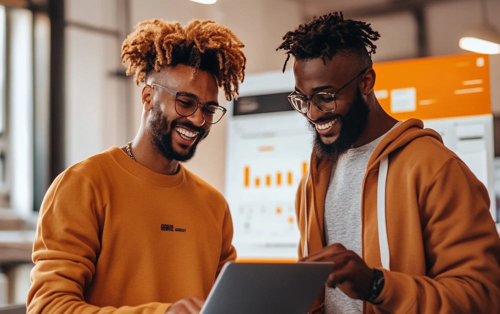 Two professionals collaborating on a laptop, analyzing data visualizations on a screen, representing seamless workflow automation with a data integration tool. Optimized for businesses seeking efficient data management and integration solutions.
