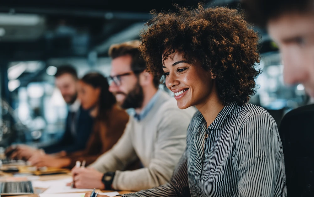 Finance professionals collaborating in a modern office, researching FloQast alternatives for automated reconciliation and financial close software solutions.