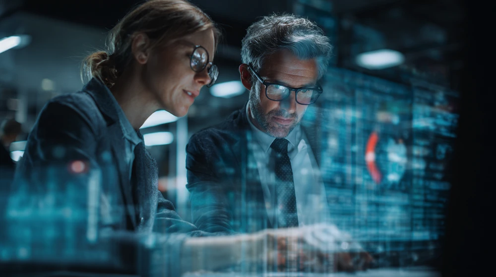 Finance professionals analyzing digital dashboards and data automation workflows, showcasing the role of BPM in financial services for improved efficiency, compliance, and decision-making.