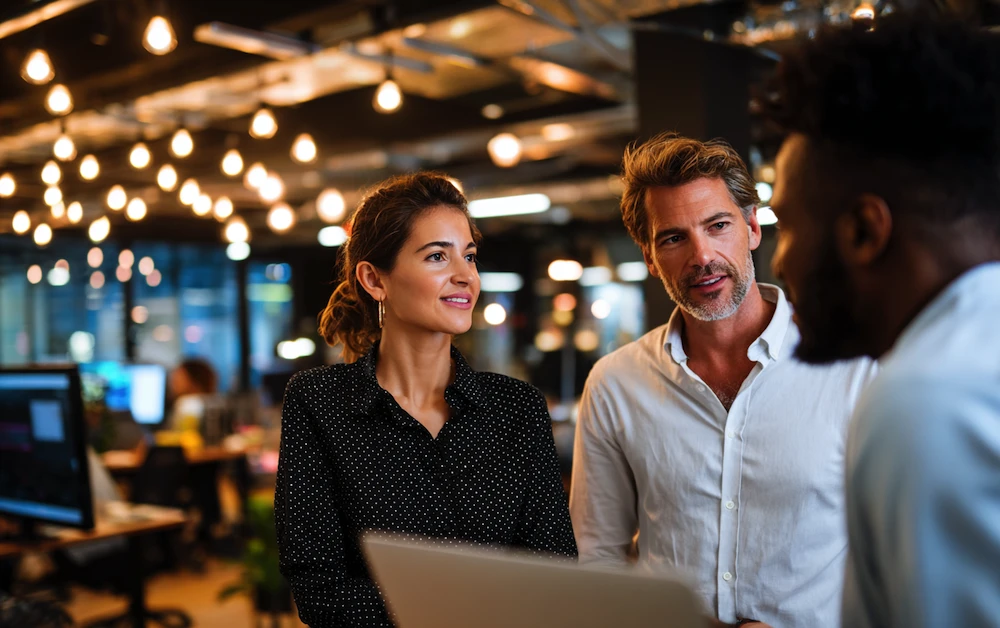 Business professionals discussing workflow improvements in a modern office, representing business process automation benefits like efficiency, collaboration, and streamlined operations.