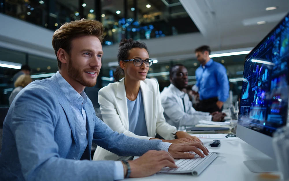 Finance and operations team using automation software in a modern office, showcasing the impact of business process automation on productivity, accuracy, and digital transformation.