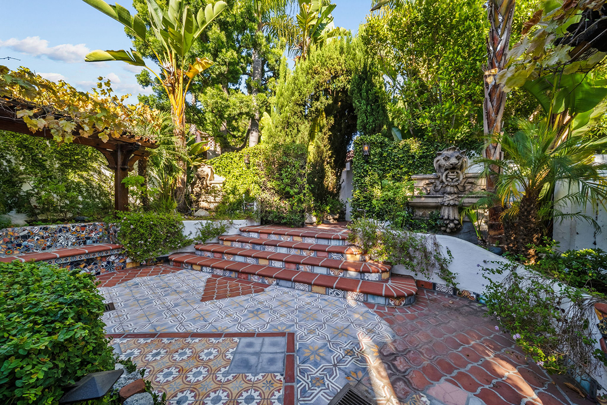 Sculpted plantings and a mélange of tiles define the courtyard entrance.