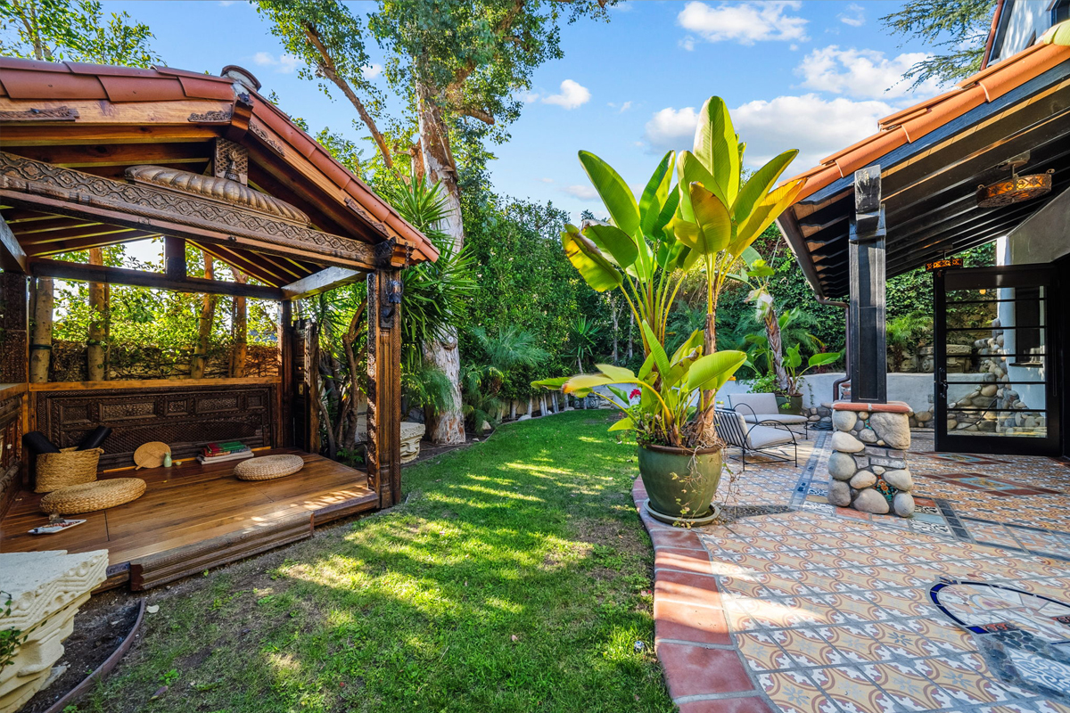 A discreet stairway next to the garage leads down to a lower yard with a tea hou