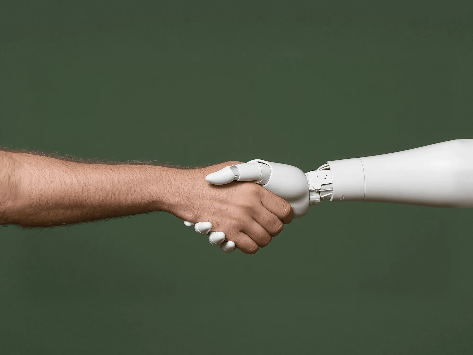 Human and robotic handshake symbolizing Purplecore Tech’s AI-driven digital solutions and human-centric technology partnerships.