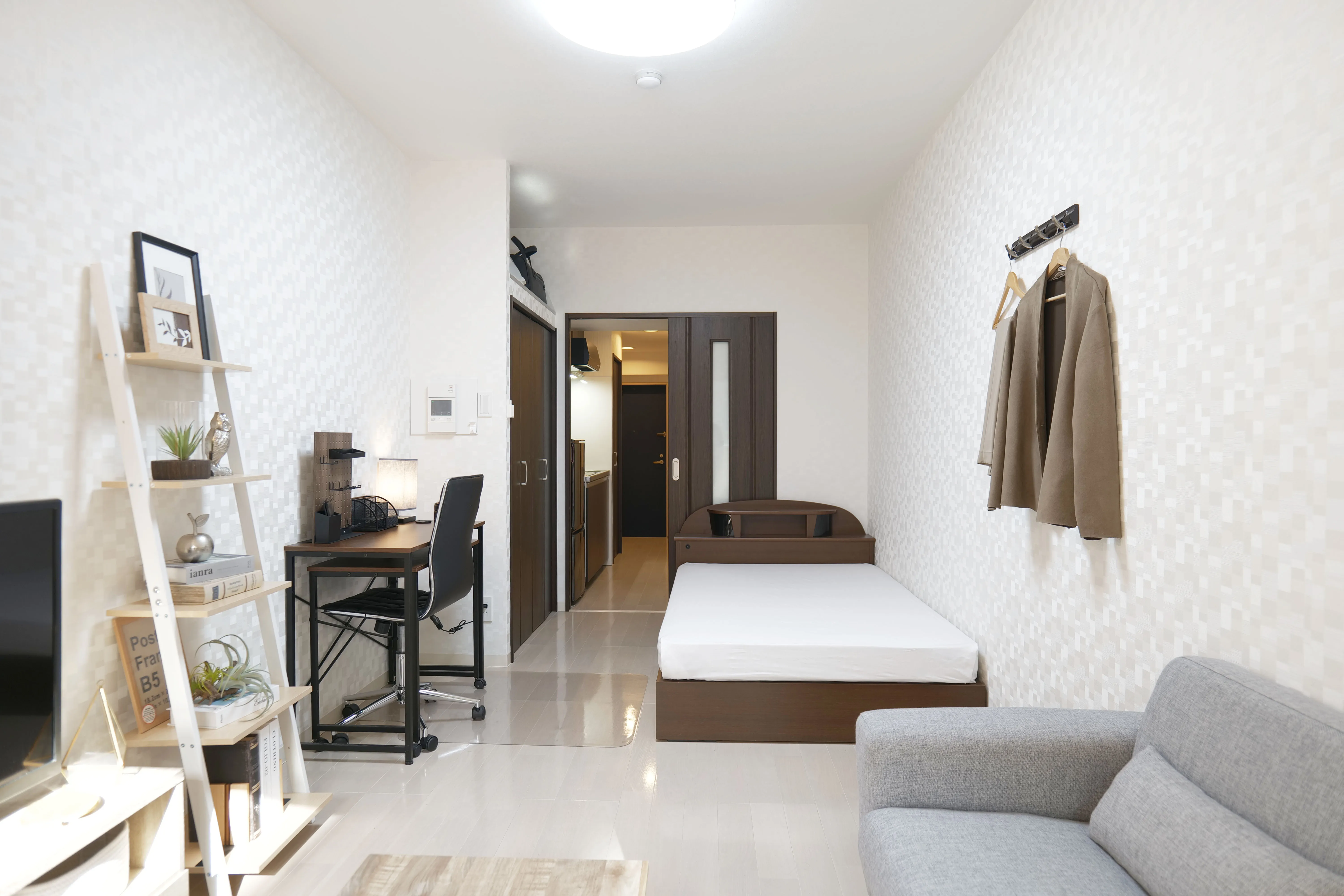 Cozy room with veranda, 2-seater sofa, center table, and flat-screen TV.