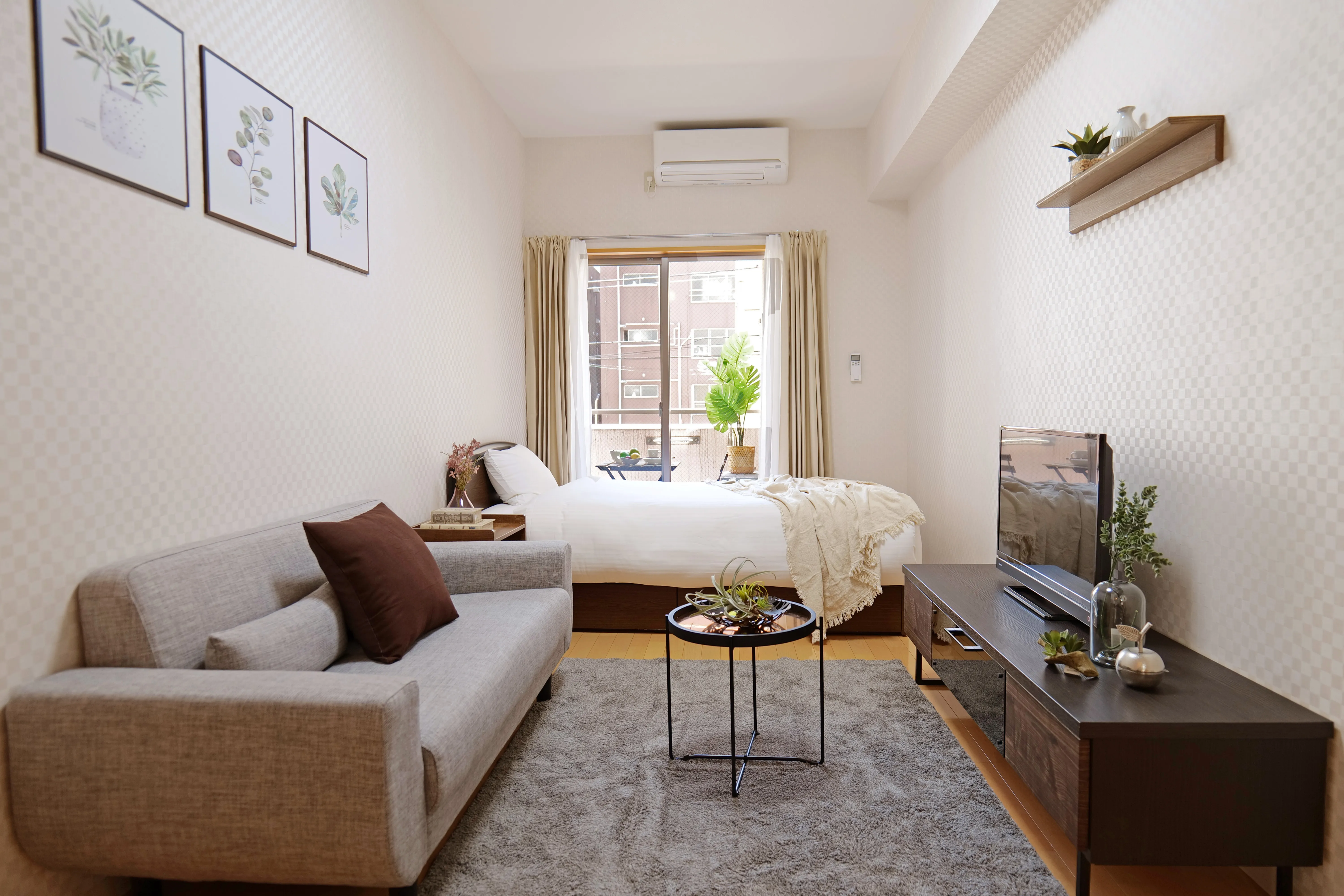 25sqm unit with double bed, 3-seater sofa, center table, and flat-screen TV.