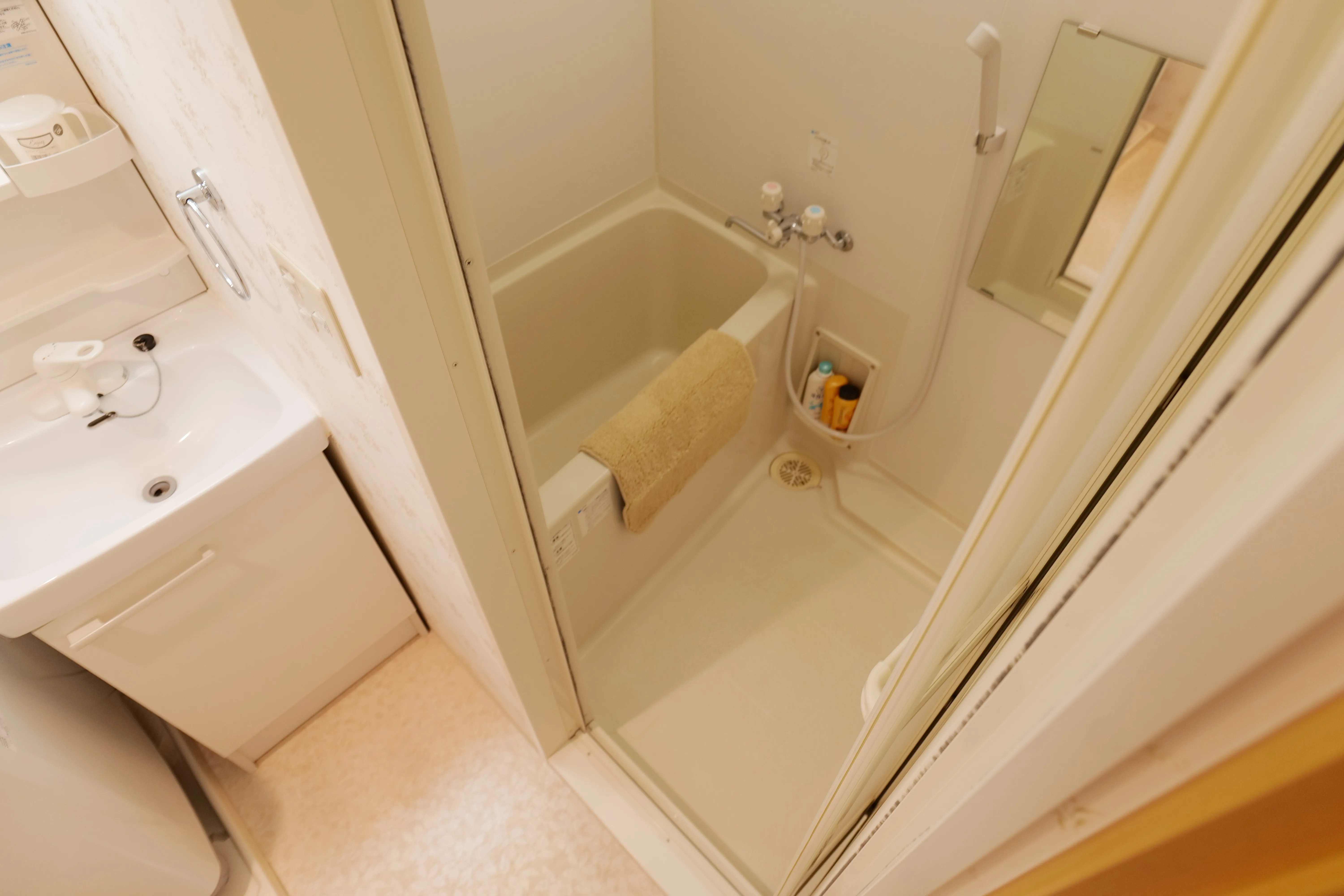Modern Japanese-style shower area with bathtub.
