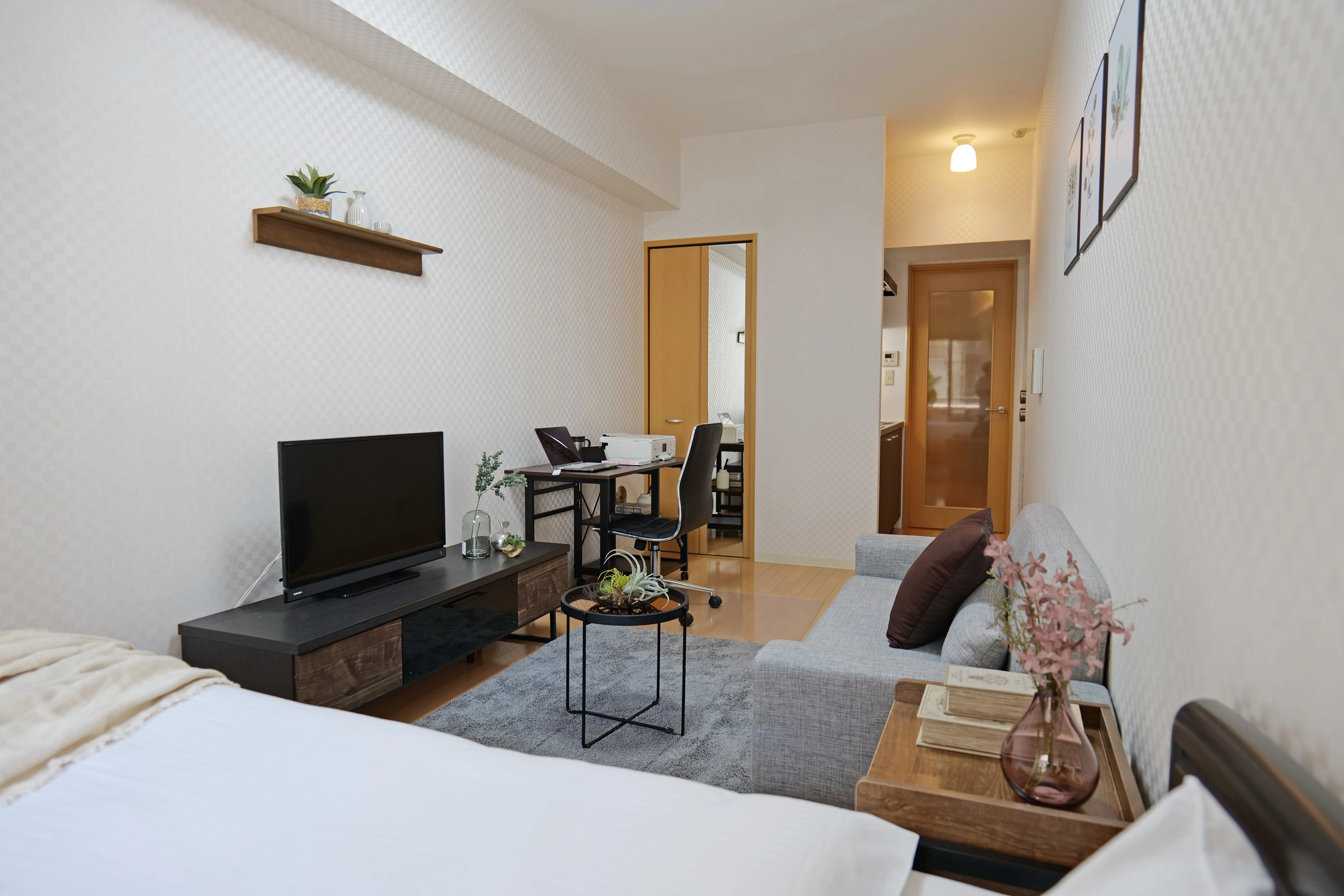 25sqm unit with double bed, 3-seater sofa, center table, and flat-screen TV.