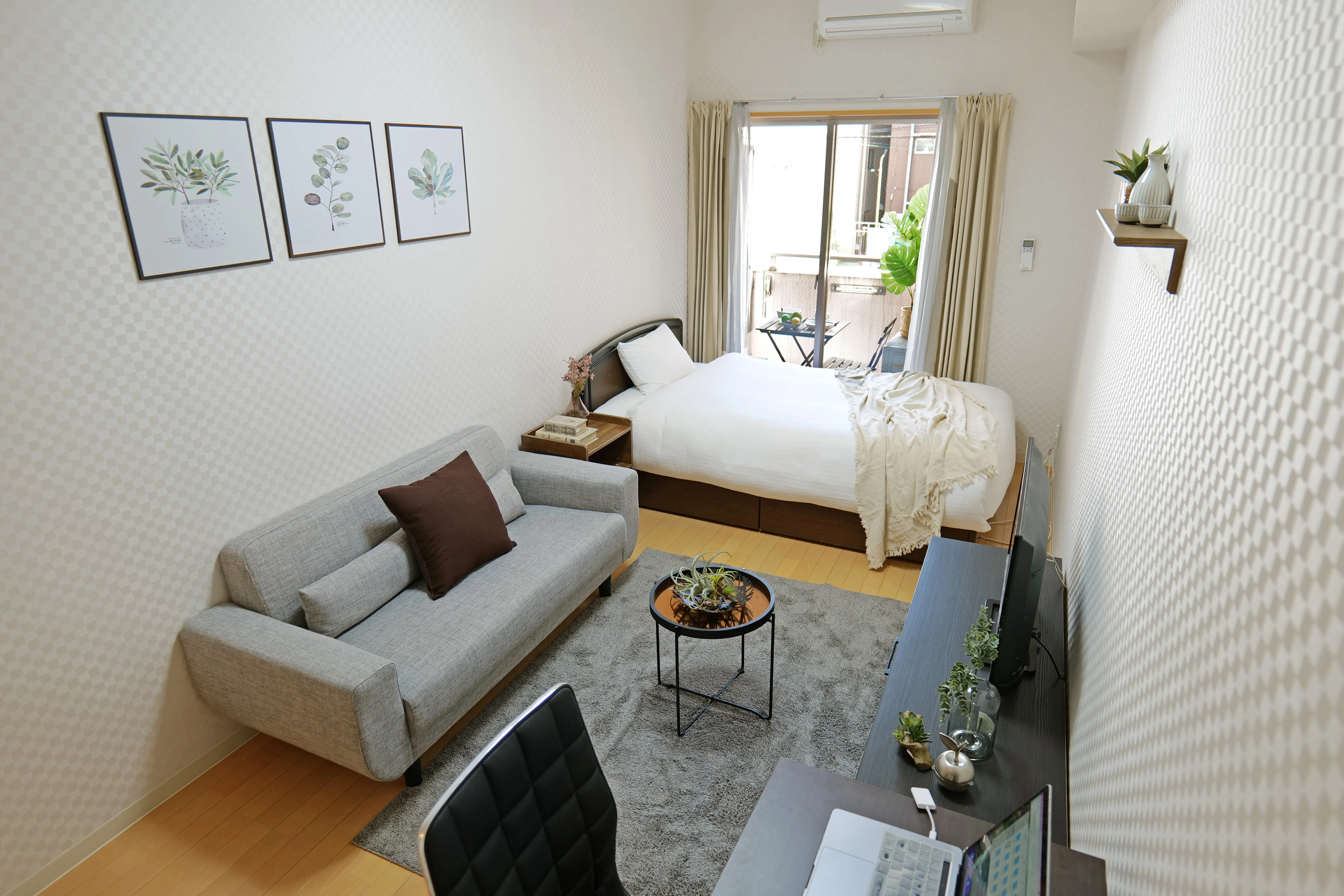 25sqm unit with double bed, 3-seater sofa, center table, and flat-screen TV.