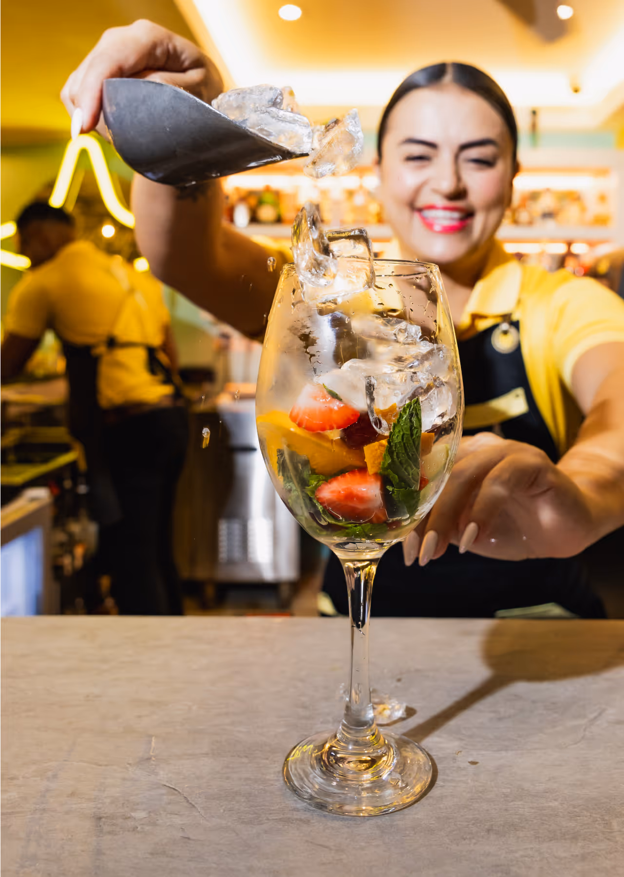 Bartender mixing tropical cocktails at Dushi Bagels & Burgers Palm Beach Aruba