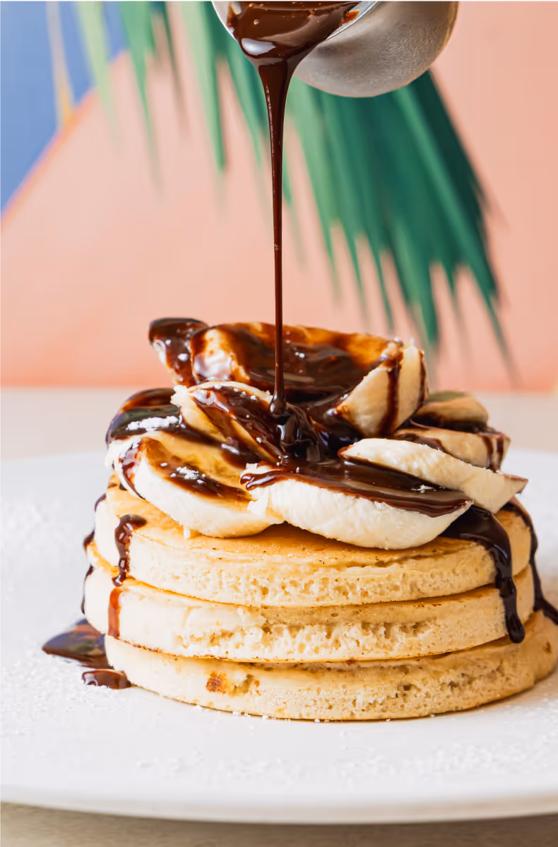 Assortment of decadent desserts and sweet treats at Dushi Bagels & Burgers Aruba including cheesecake and ice cream sundaes