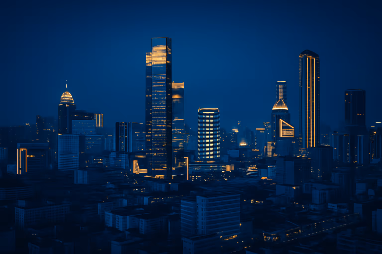 City skyline at dusk with skyscrapers illuminated.