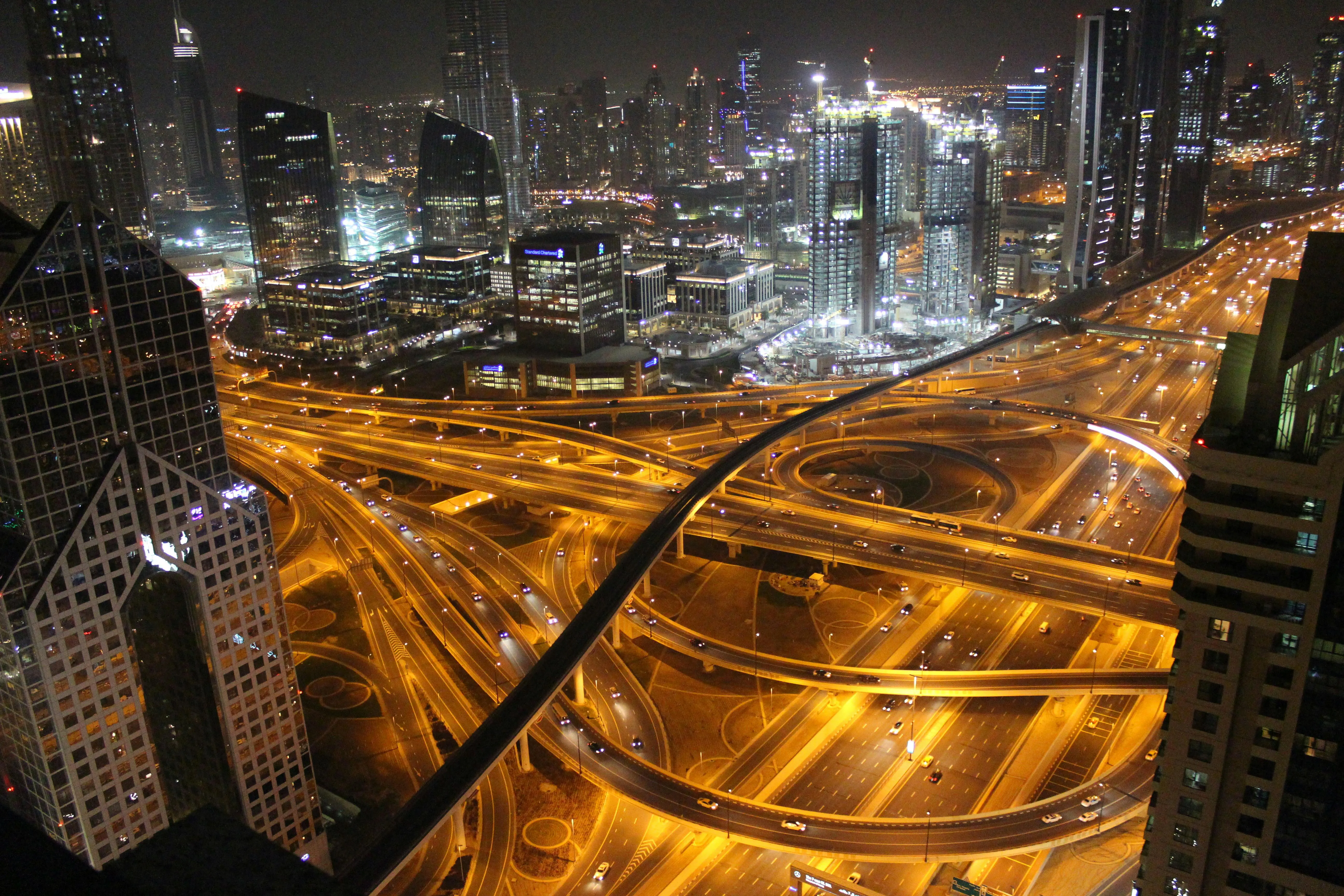 Aerial view of a brightly lit highway interchange at night.