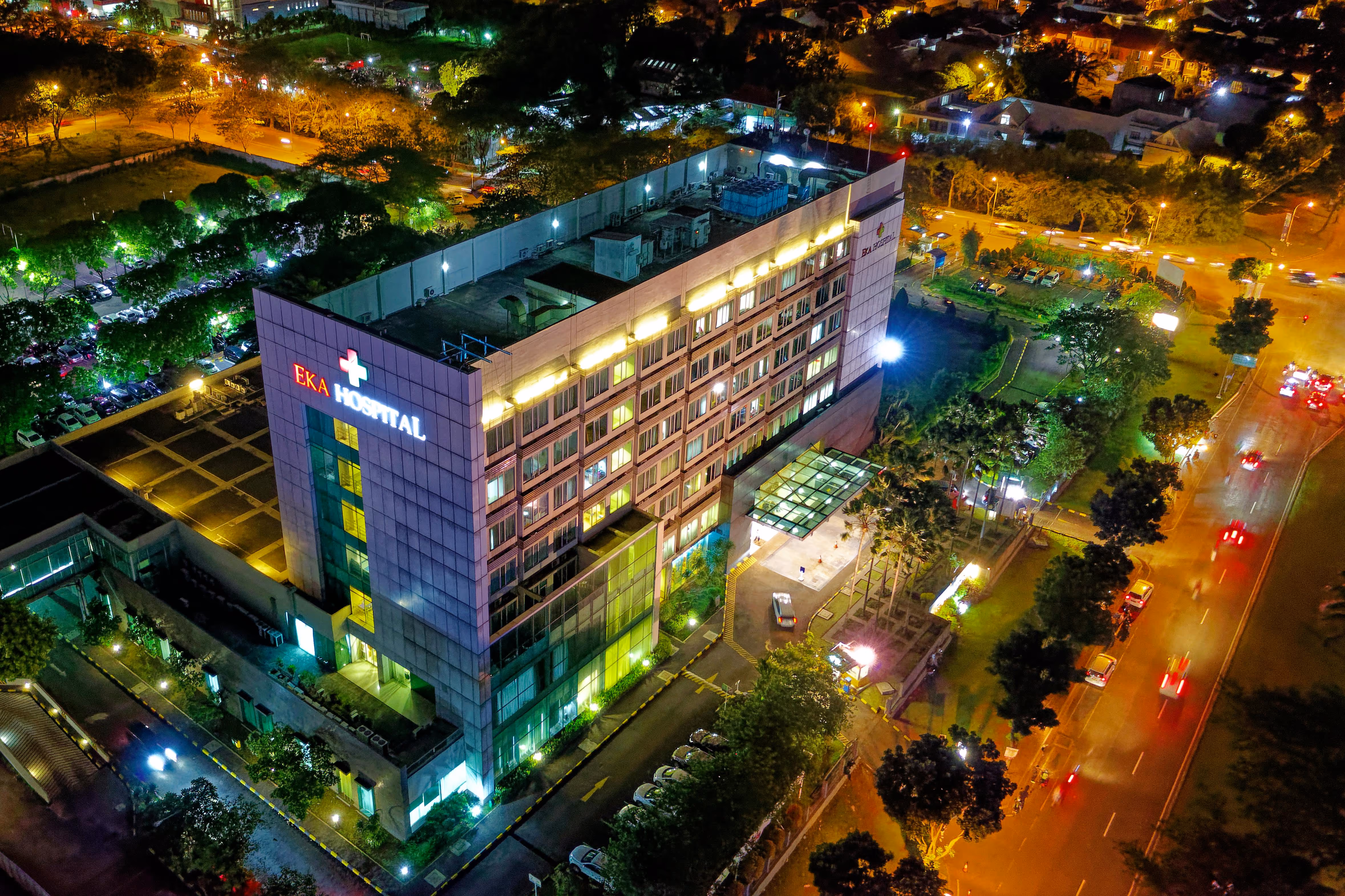 Aerial cityscape view at night with bright lights.