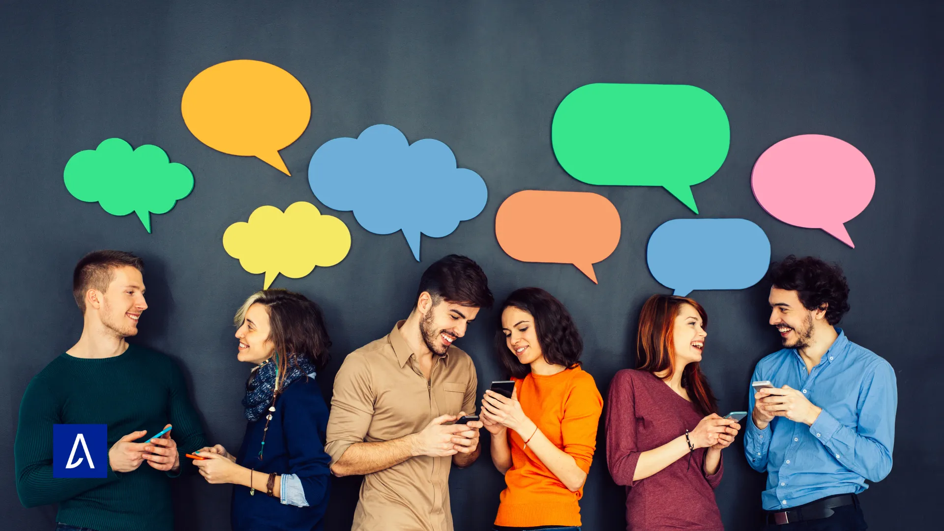 roupe de jeunes discutant et utilisant leurs téléphones devant un mur décoré de bulles de dialogue colorées.