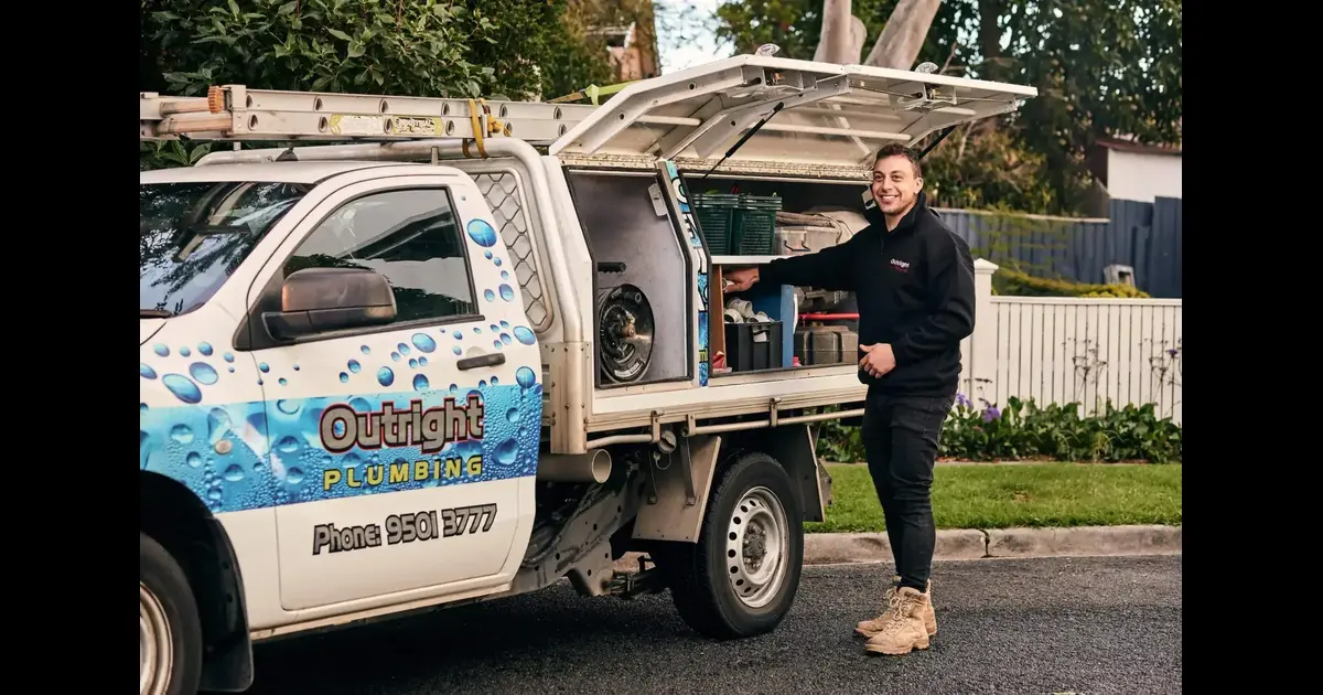 An Outright plumber arriving with a fully-stocked van in a Melbourne driveway