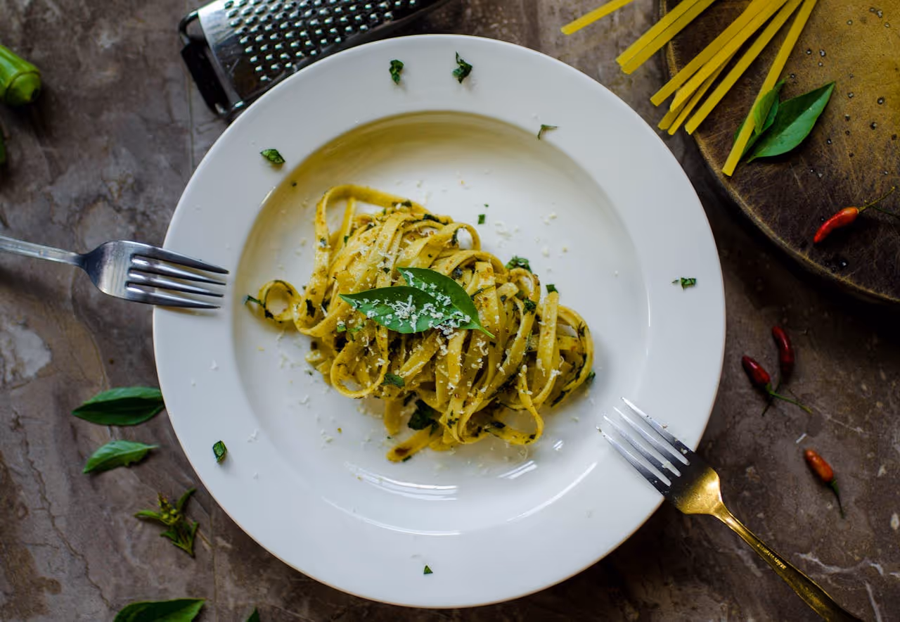 A dish of fresh pasta with pesto.