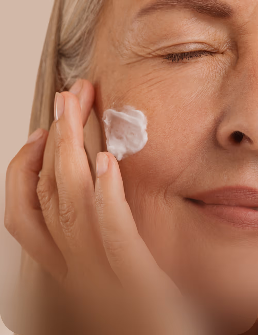 Women putting skincare cream on her face