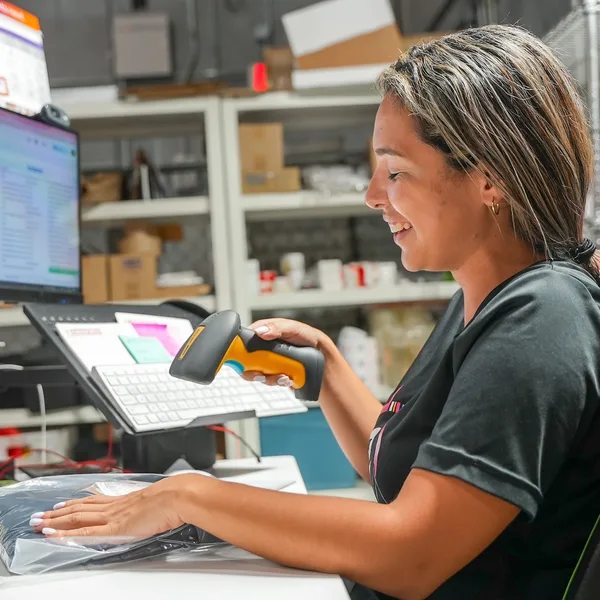 Team member relabeling products with a barcode scanner