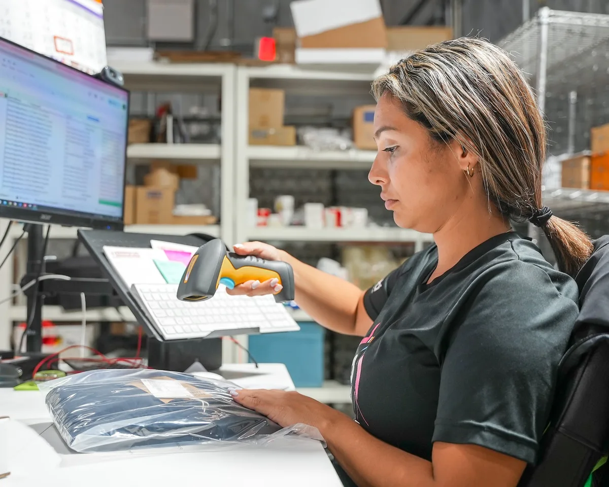 Team member inspecting a returned pet accessory