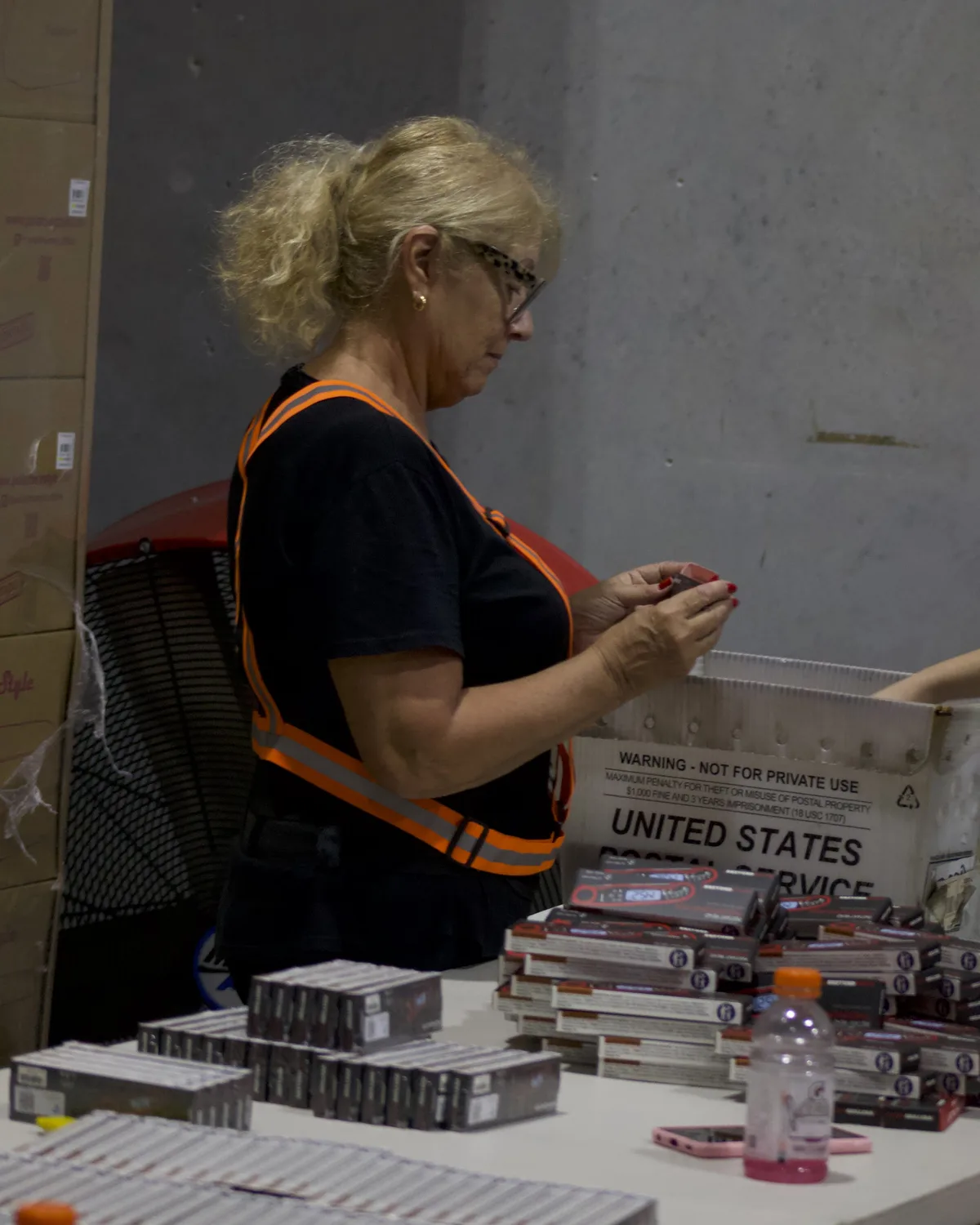 Team member scanning supplement cartons on a labeled pallet
