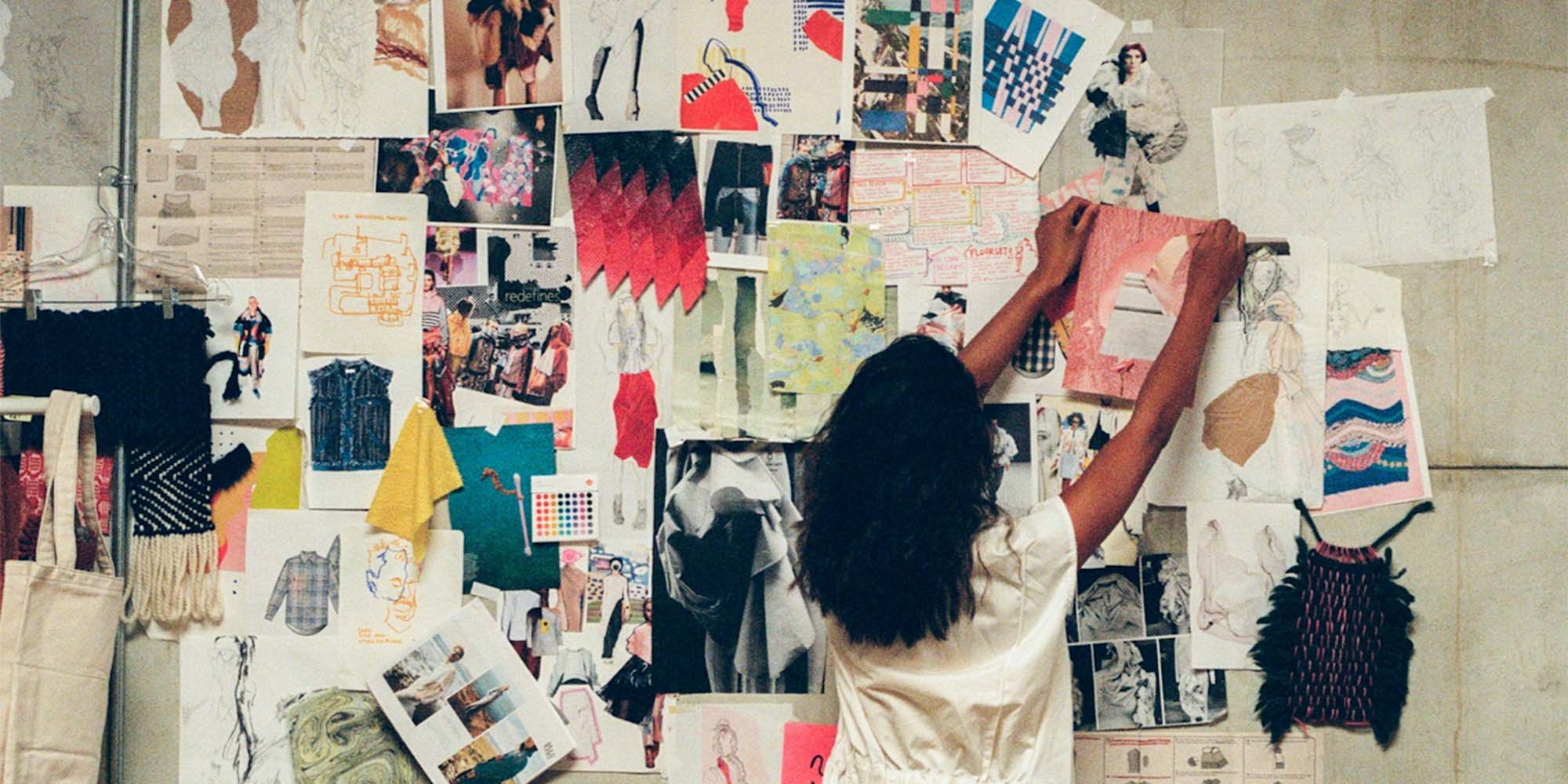 woman standing by moodboard on wall