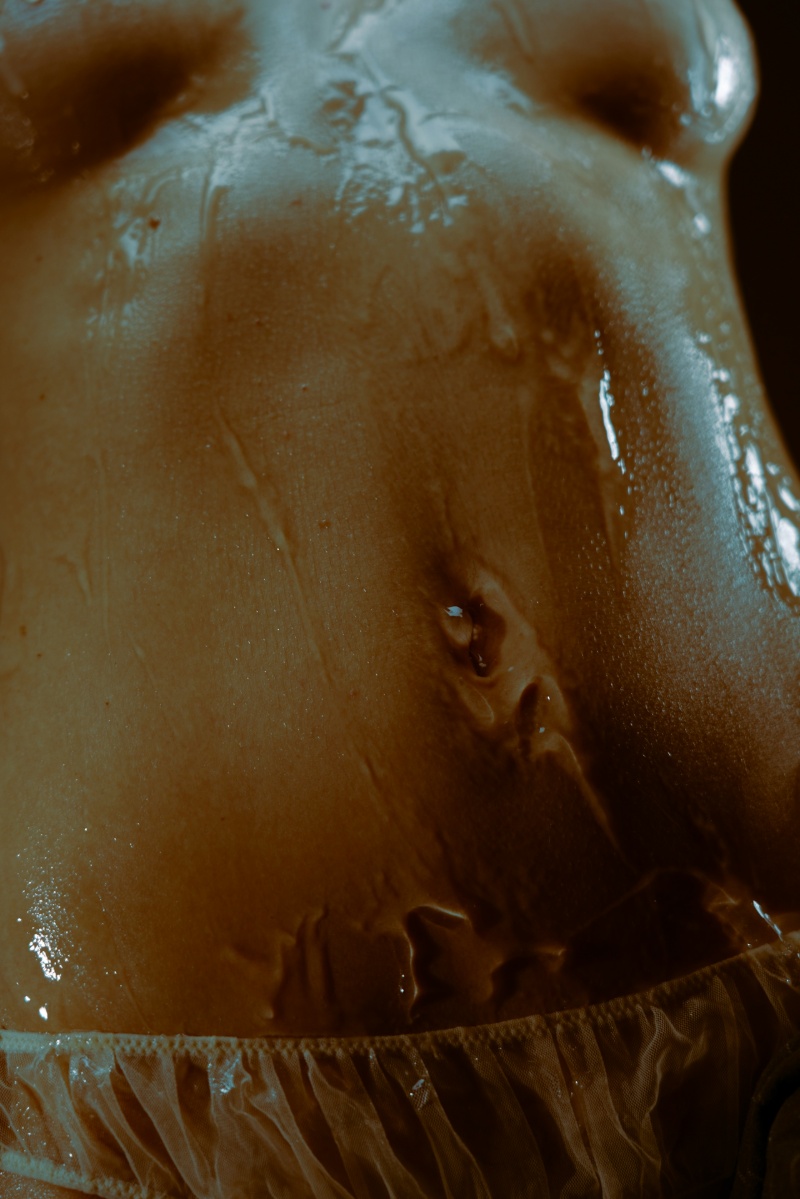 Woman with oil on her belly. 