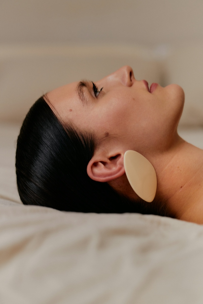 woman wearing earrings looking at sky