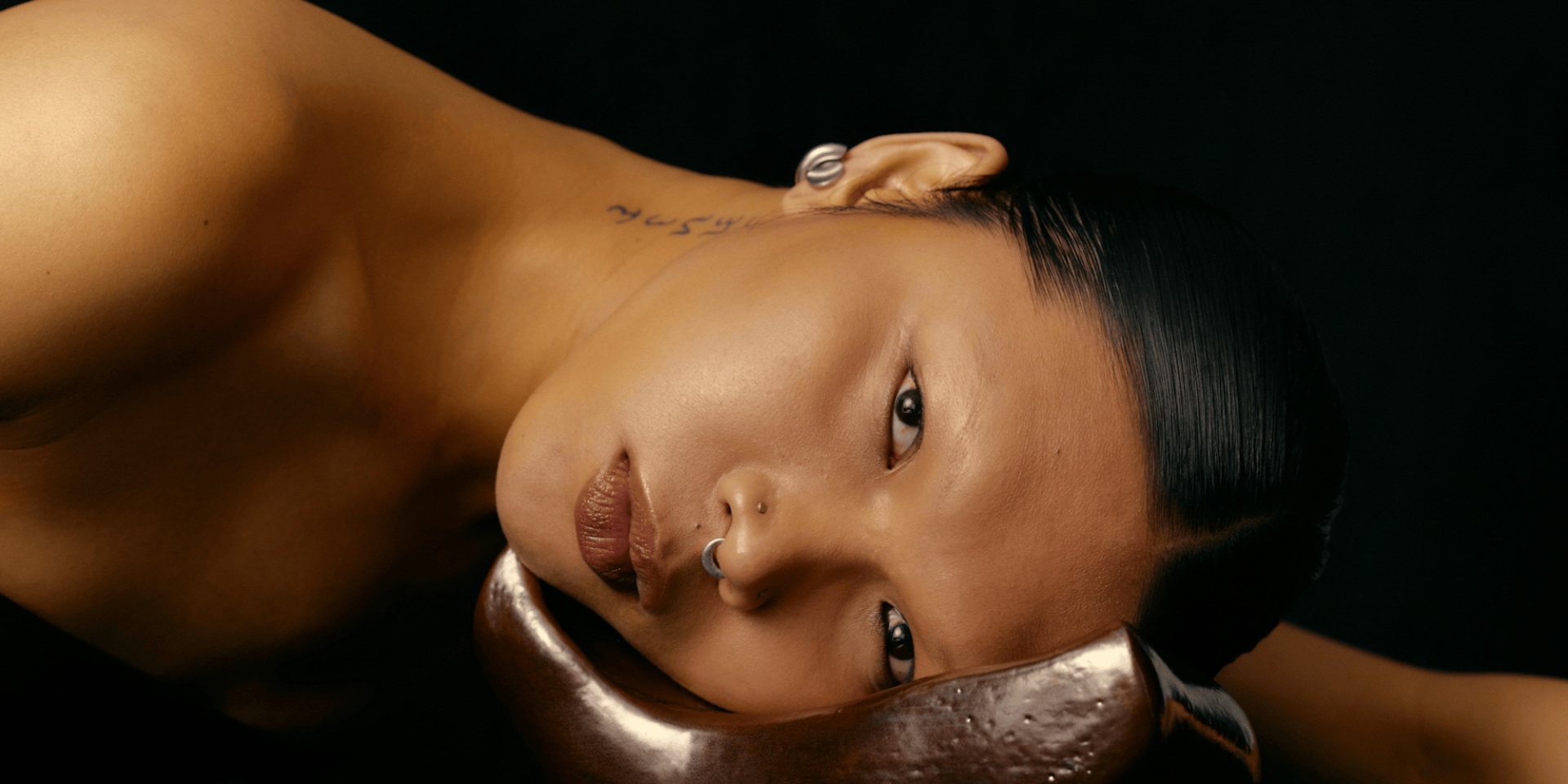 woman lying on silver dish
