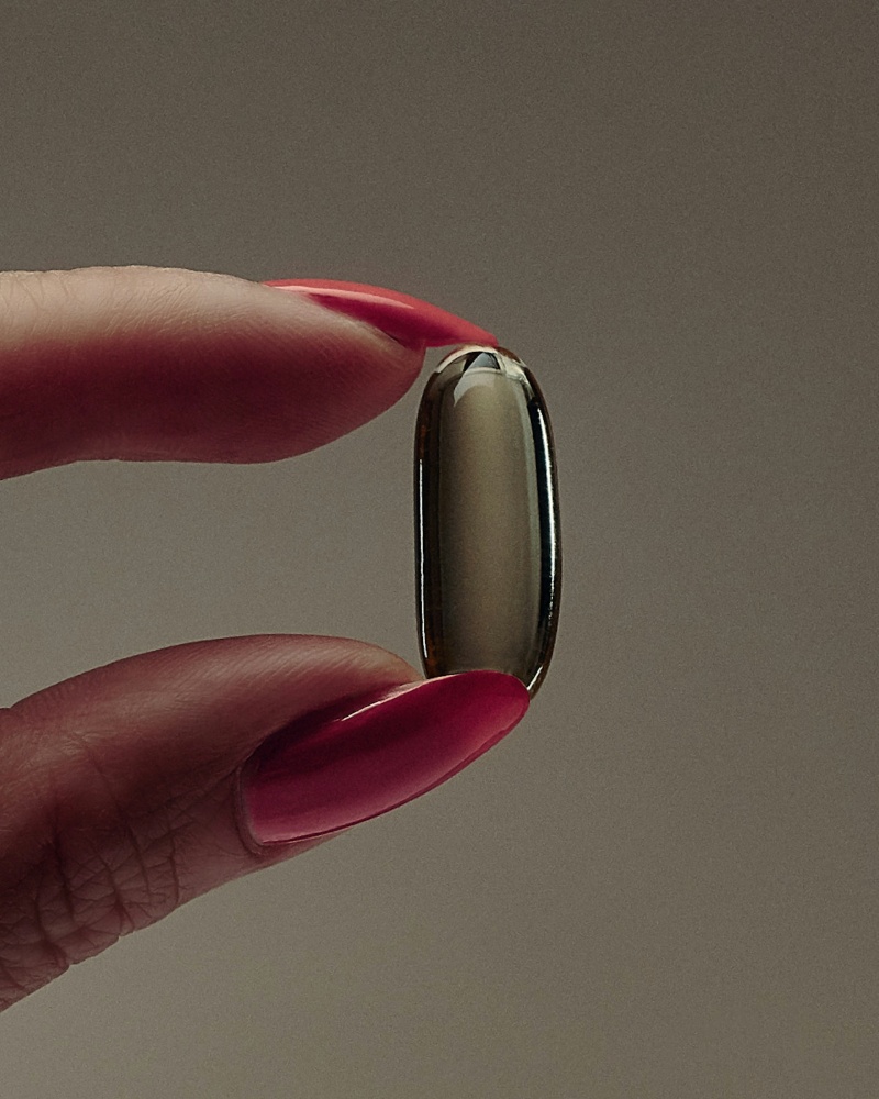 pill held with fingers