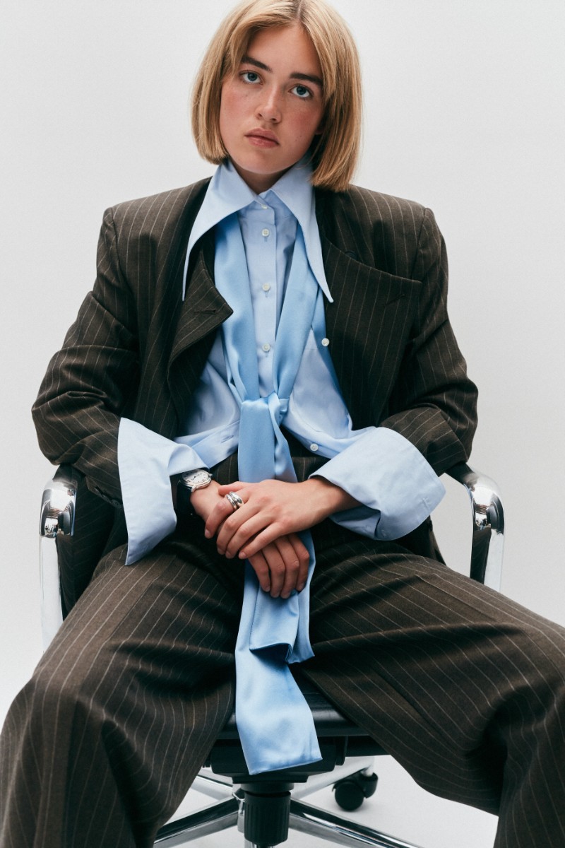 model wearing Laura Pitharas brown suit blue shirt