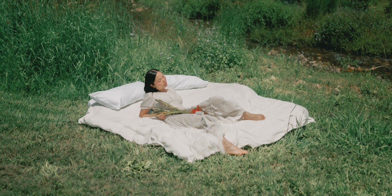 woman on blanket in field