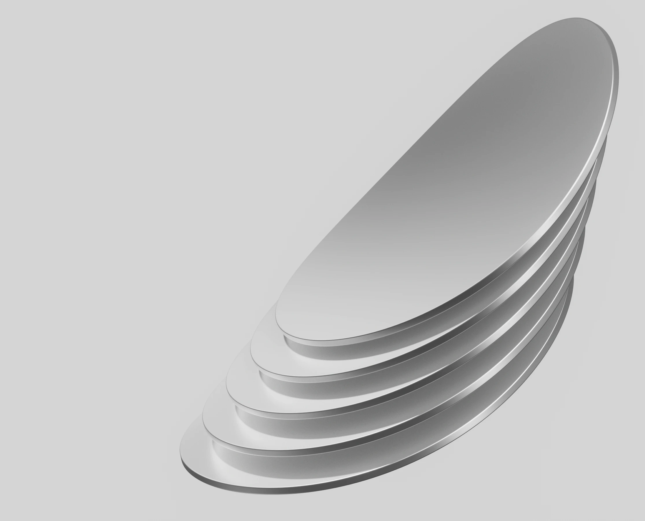 Stack of five smooth, oval-shaped silver metallic discs arranged in a stepped pattern against a light gray background.