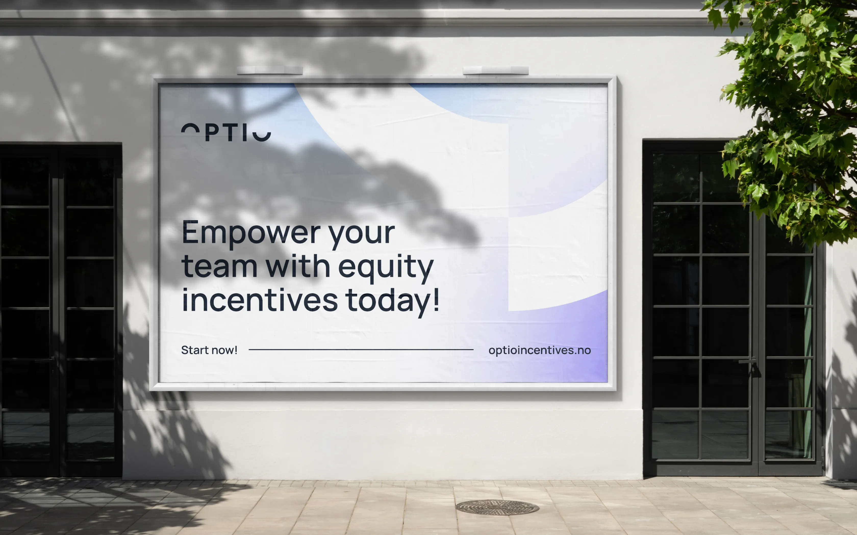Outdoor billboard on a white wall between two glass doors, displaying text 'Empower your team with equity incentives today!' and the website optioincentives.no.