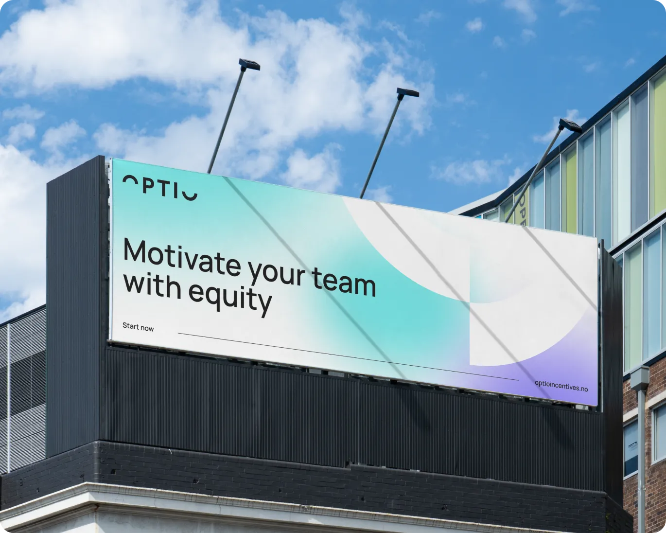 Billboard on a building reading 'Motivate your team with equity' under a blue sky with clouds.