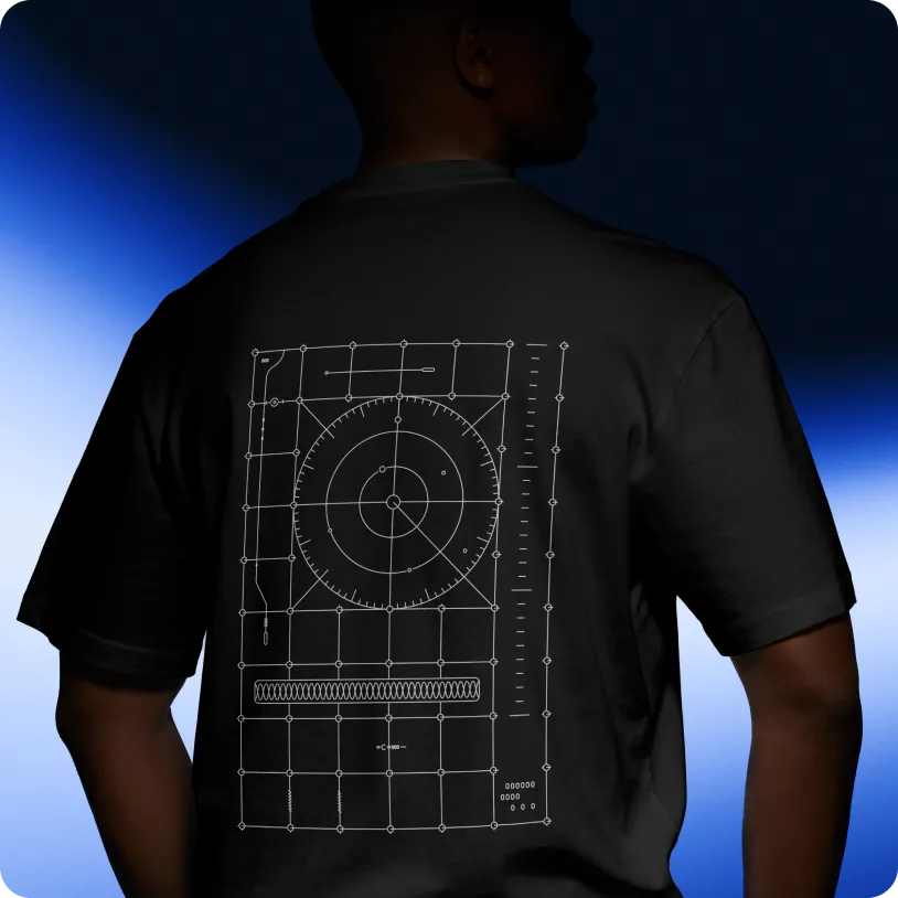 Person wearing a black t-shirt with a white geometric technical diagram featuring a circular gauge and grid lines on the back.