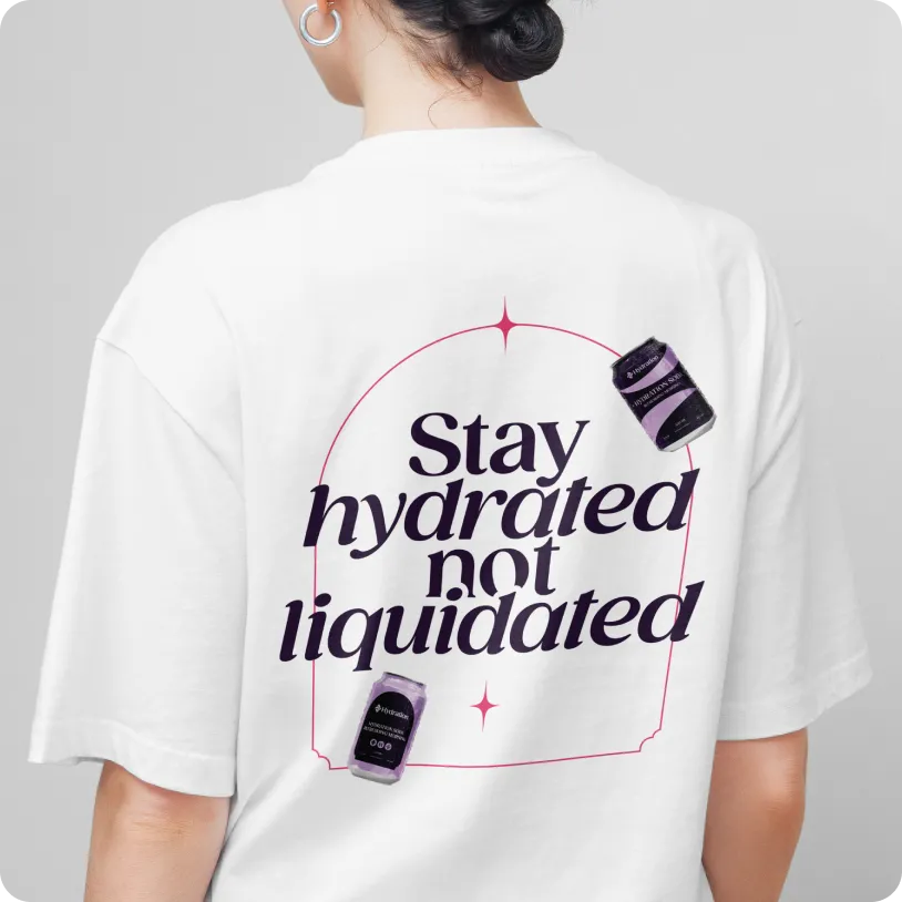 Person wearing a white t-shirt with the text ‘Stay hydrated not liquidated’ and images of hydration supplements on the back.