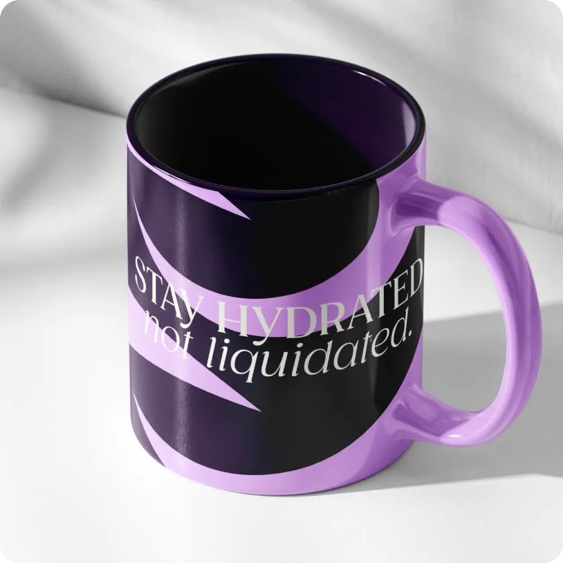 Black and purple ceramic mug with the phrase 'STAY HYDRATED not liquidated.' printed on it.