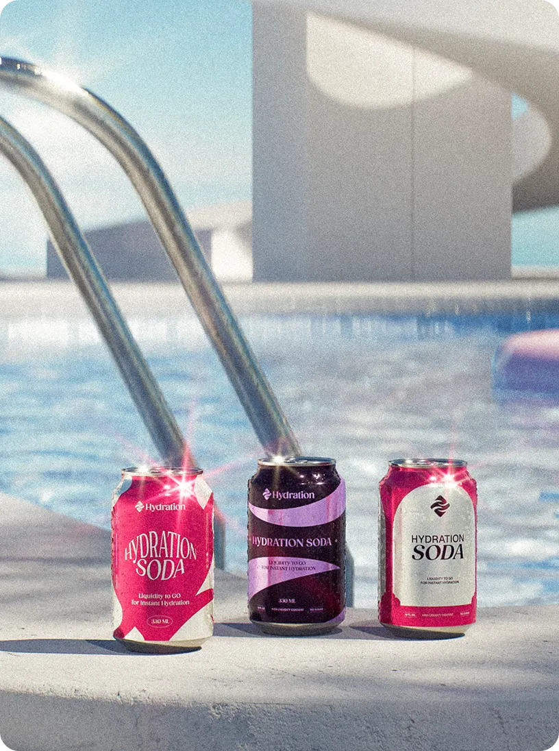 Three colorful cans of Hydration Soda placed on the edge of a swimming pool near a metal pool ladder under sunlight.