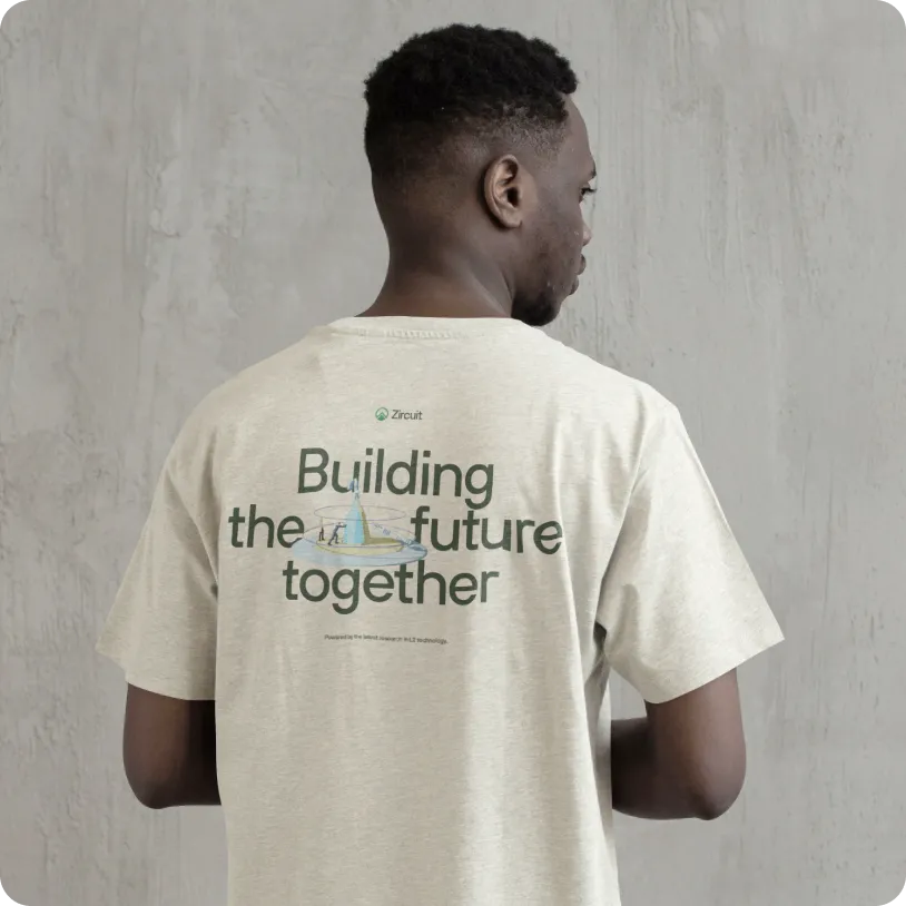 Man seen from behind wearing a beige t-shirt with the text 'Building the future together' and a small logo above it.
