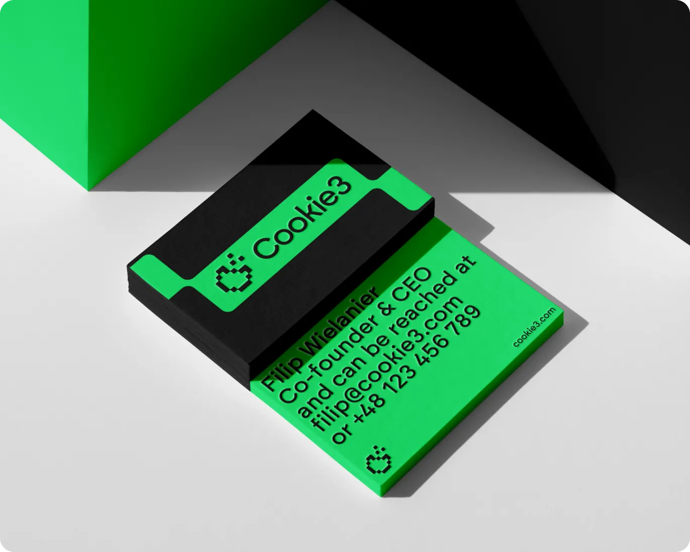 Green and black business card for Cookie3, displaying contact information of Filip Wielanier, Co-founder & CEO, with email and phone number.