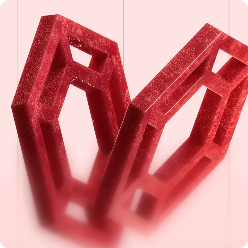 Two red geometric, hollow, textured 3D shapes with sharp edges suspended against a pale pink background.