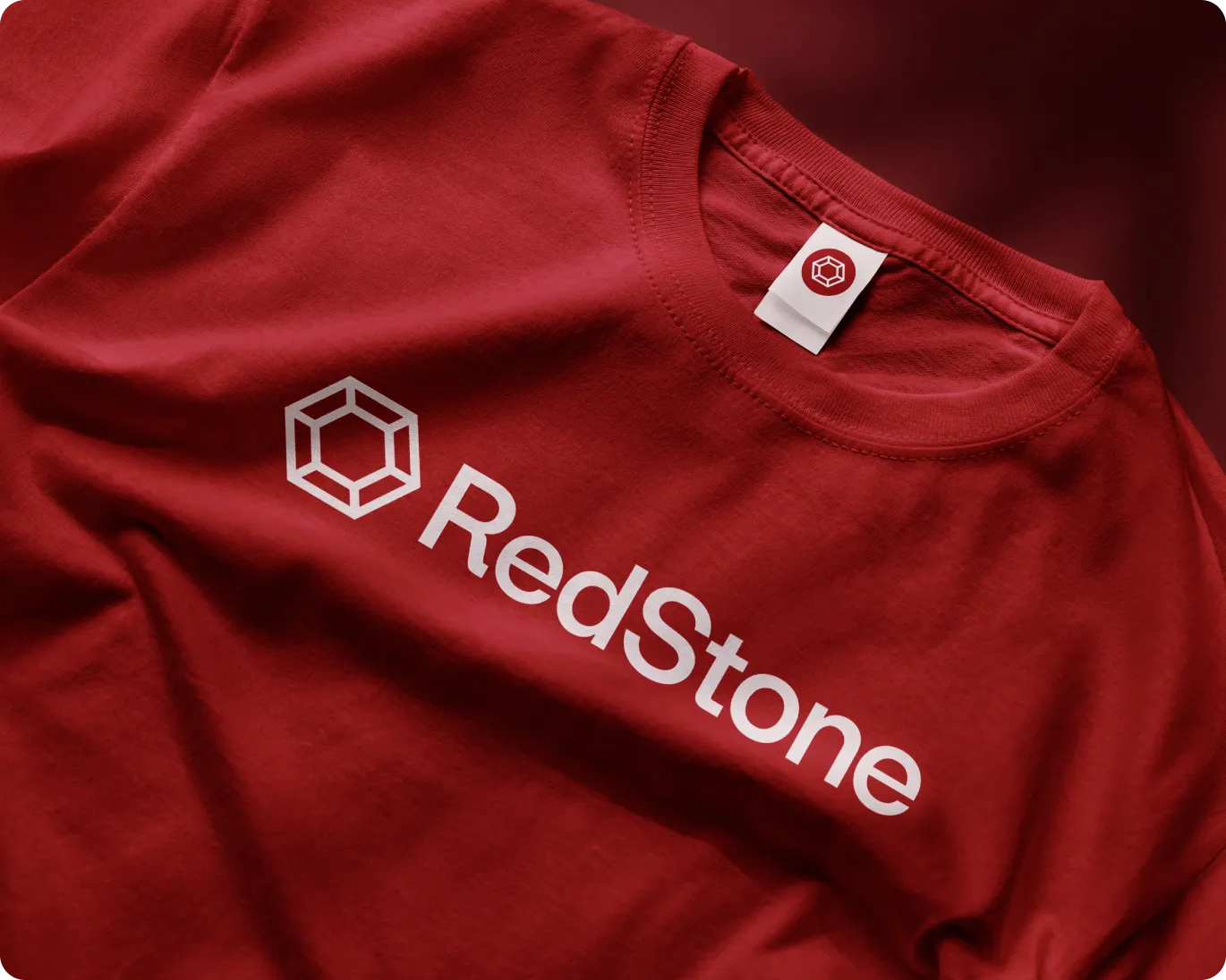 Red T-shirt with a white geometric logo and the text 'RedStone' printed on the front.