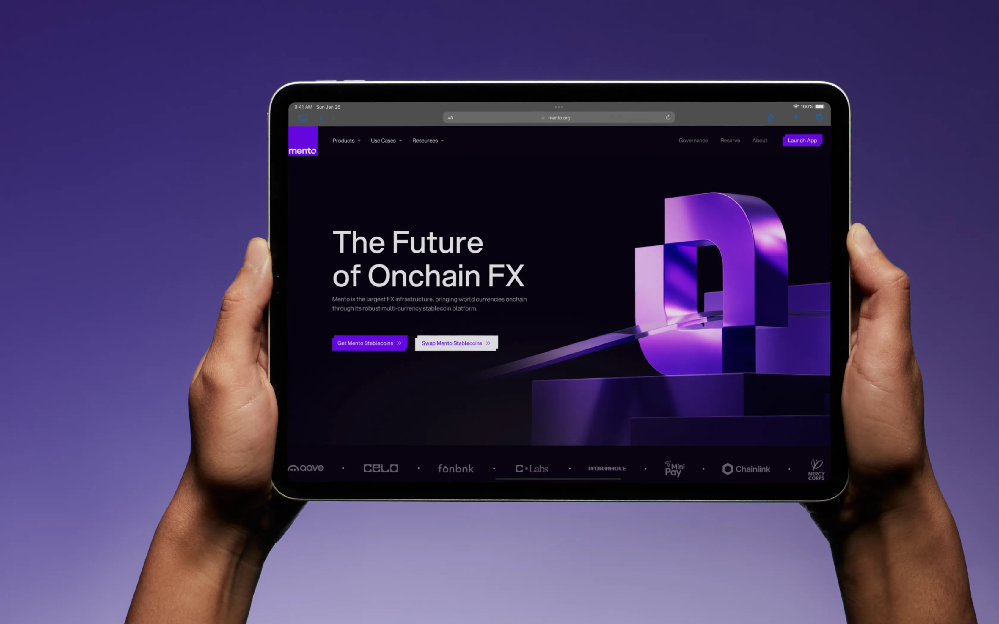 Tablet held by hands displaying Mento website homepage with the headline 'The Future of Onchain FX' and purple 3D logo.