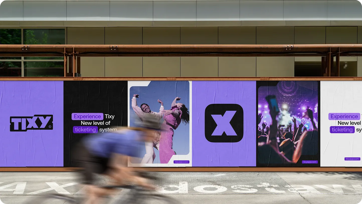 Outdoor advertisement for Tixy featuring the logo, a playful couple dancing, a crowd at a concert, and text promoting a new ticketing experience.