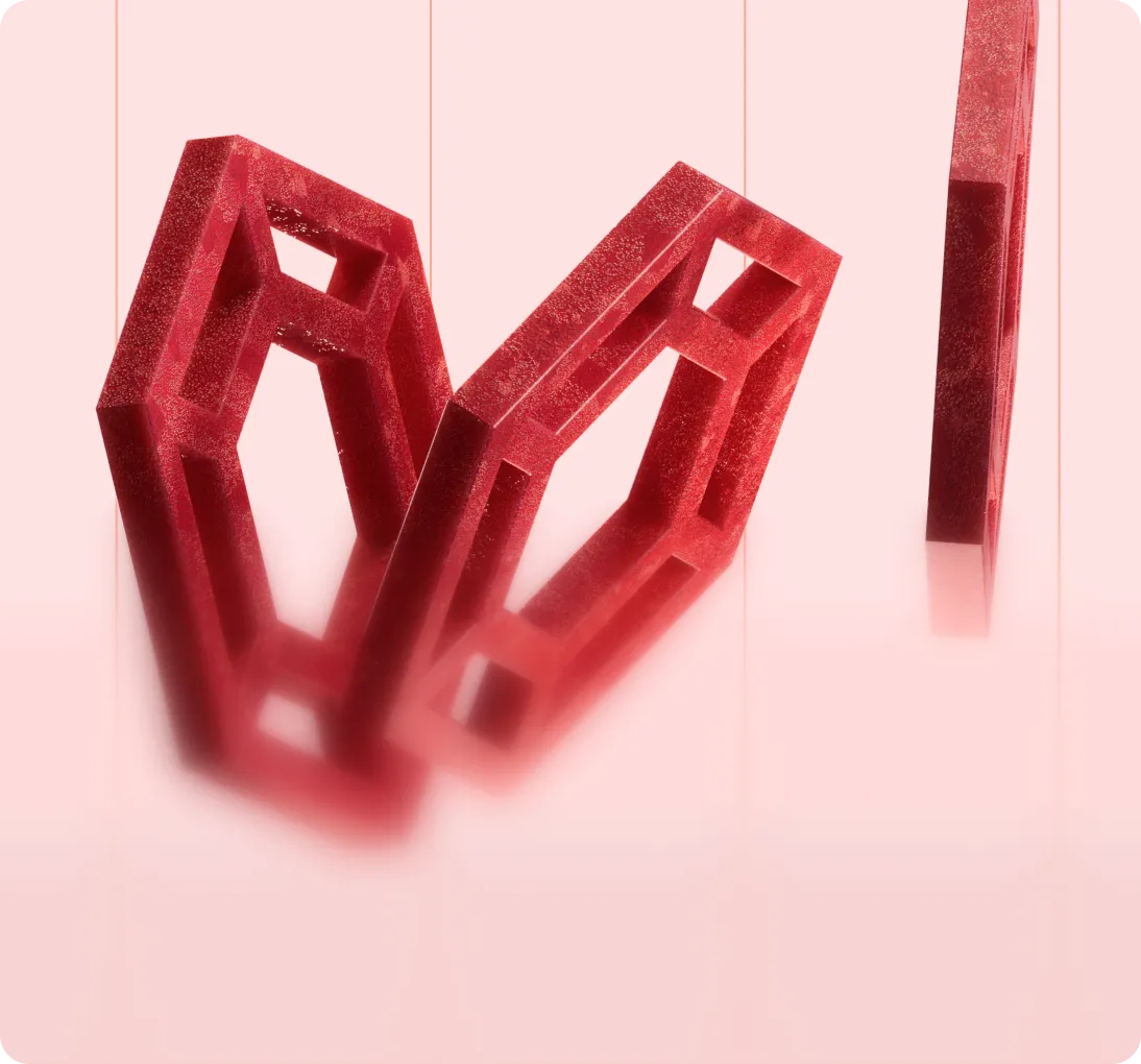 Three red geometric hollow shapes suspended by thin strings against a soft pink background.