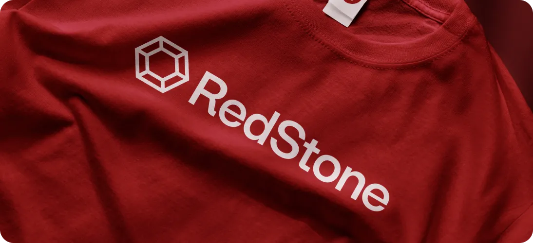 Red T-shirt with a white geometric logo and the word 'RedStone' printed on it.