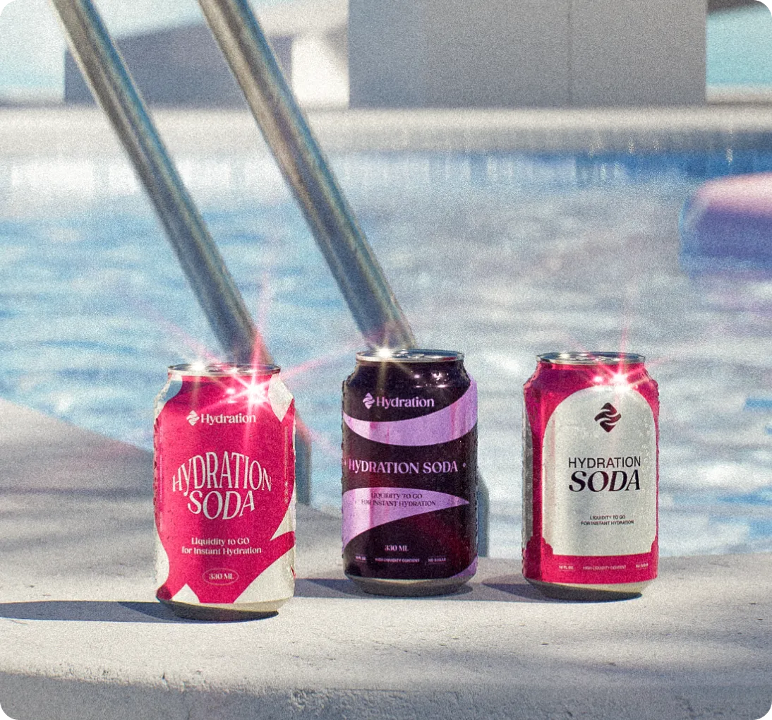 Three cans of Hydration Soda placed on the edge of a pool with metal pool ladder in the background.
