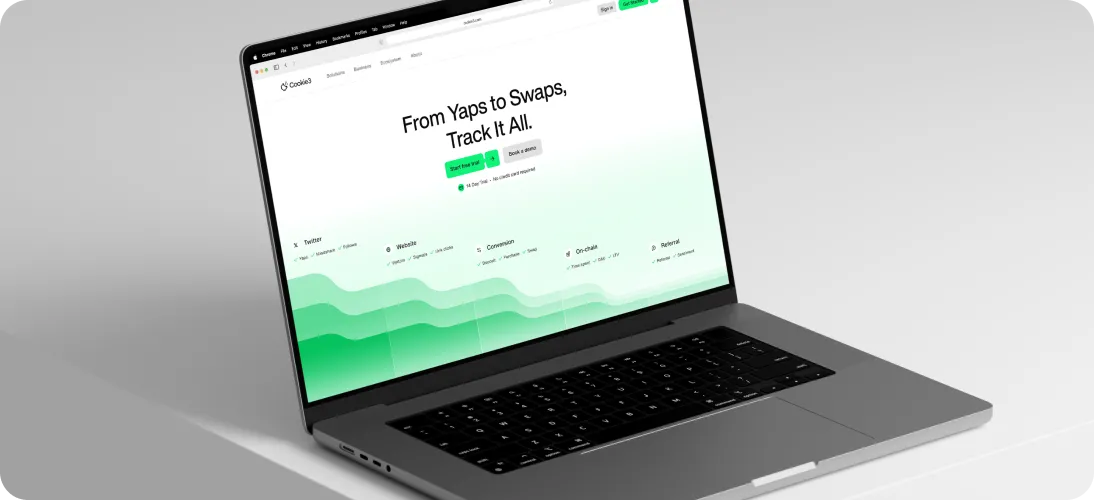 Open laptop displaying a website homepage with the headline 'From Yaps to Swaps, Track It All.' and green gradient elements.